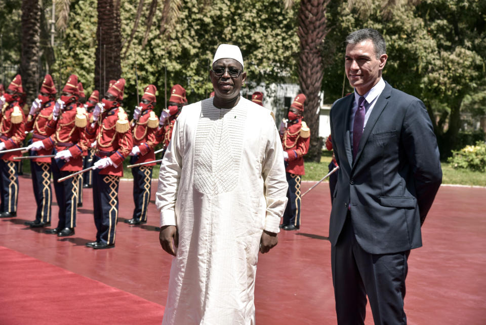 Spanish Prime Minister Pedro Sanchez, right, is received by Senegalese President Macky Sal at the Palace of the Republic in Dakar, Senegal, Friday, April 9 2021 after his meeting with Senegalese President Macky Sall. Sanchez is on a mini-tour to two African nations that are key in the European country's new push to bolster ties with the neighboring continent and mitigate the migration flows that many fear could increase as a consequence of the coronavirus pandemic.(Seyllou/Pool Photo via AP)