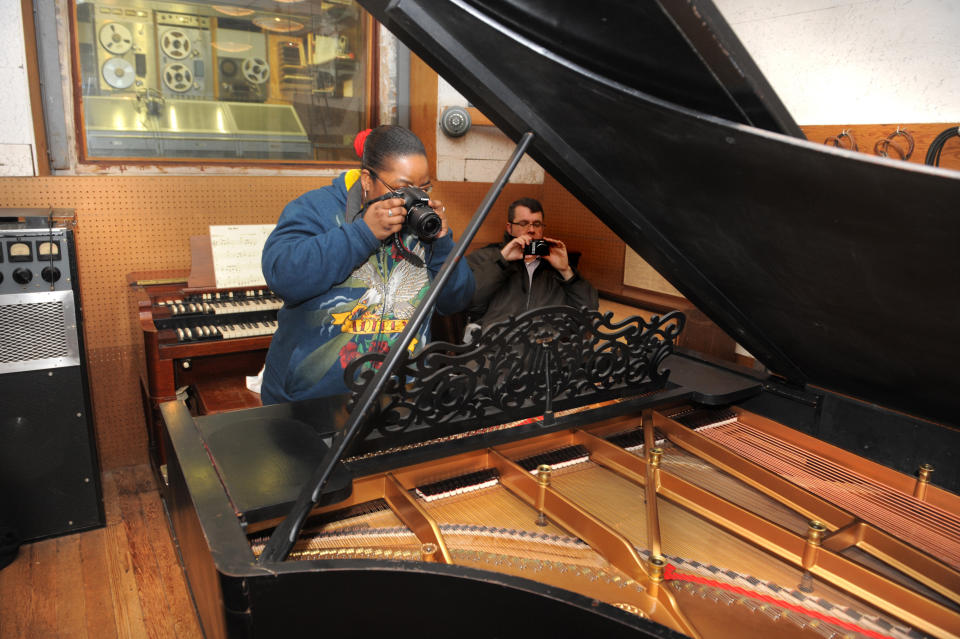 Michael Renee Dozler photographs the famed piano on Monday, April 1, 2013. Detroit's Motown Museum installed its prized Steinway grand piano back into Studio A. (AP Photo/The Detroit News, Max Ortiz)