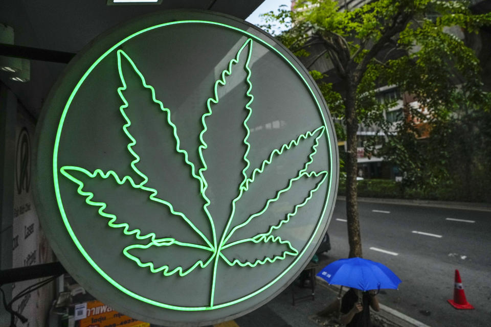 Pedestrian walk under sign Cannabis shop in Bangkok, Thailand, Wednesday, May 15, 2024. Prime Minister of Thailand Srettha Thavisin said Wednesday, May 8, 2024 that he wants cannabis to be officially classified as a narcotic drug, a rollback from the complete decriminalization of the plant two years ago. (AP Photo/Sakchai Lalit)