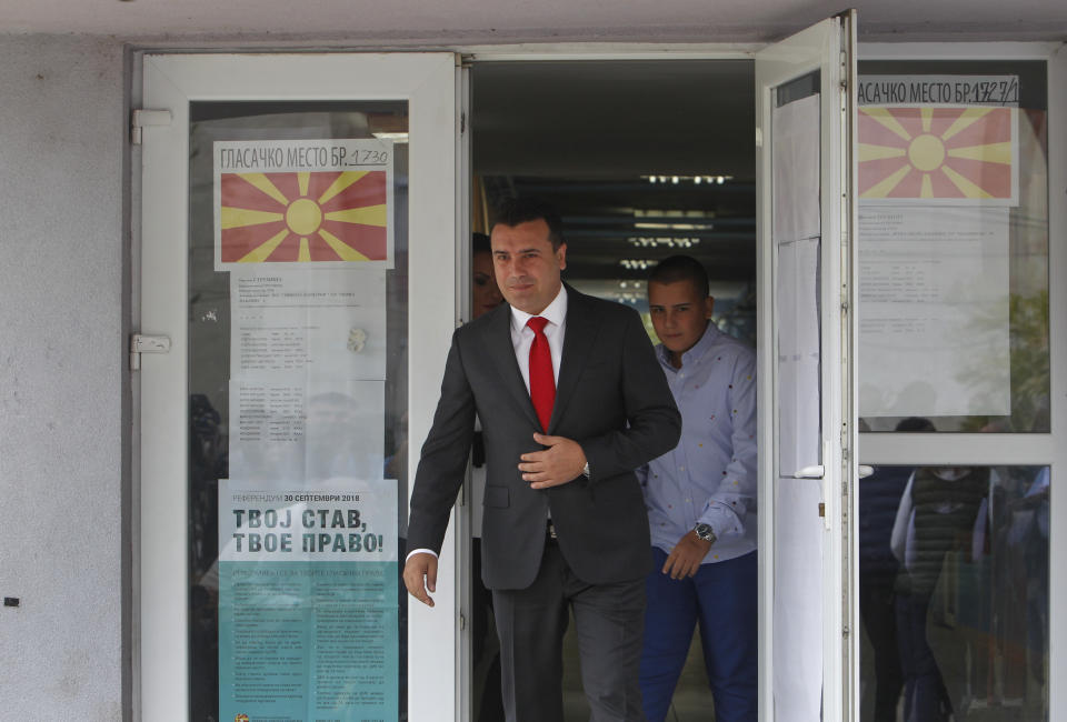 Macedonian Prime Minister Zoran Zaev, followed by his son Dusko, right, exits a polling station after casting his ballot during a referendum in Strumica, southeastern Macedonia, Sunday, Sept. 30, 2018. Macedonians were deciding Sunday on their country's future, voting in a crucial referendum on whether to accept a landmark deal ending a decades-old dispute with neighbouring Greece by changing their country's name to North Macedonia, to qualify for NATO membership and also pave its way toward the European Union. (AP Photo/Boris Grdanoski)