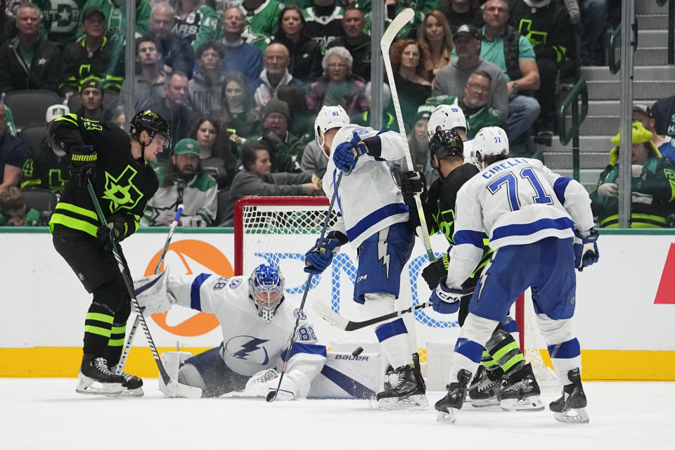 Tampa Bay Lightning goaltender Andrei Vasilevskiy (88) makes a safe as Dallas Stars center Roope Hintz, left, attacks during the second period of an NHL hockey game, Saturday, Dec. 2, 2023, in Dallas. (AP Photo/Julio Cortez)