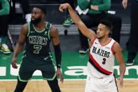 Portland Trail Blazers' CJ McCollum (3) shoots a 3-pointer against Boston Celtics' Jaylen Brown (7) during the second half of an NBA basketball game, Sunday, May 2, 2021, in Boston. (AP Photo/Michael Dwyer)