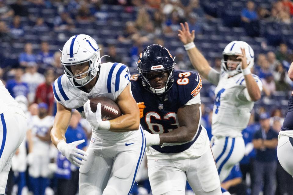 Indianapolis Colts running back Jake Funk (37) runs the ball for the go ahead touchdown while Chicago Bears defensive tackle D'Anthony Jones (63) defends in the second half at Lucas Oil Stadium.