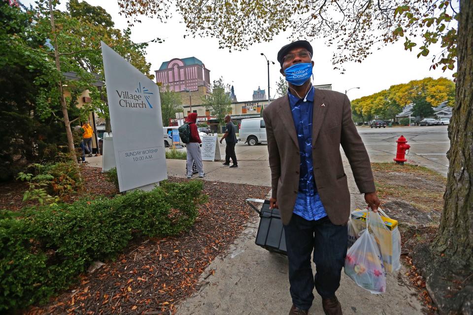 Valentinus Triggs, 49, leaves the Village Church in Milwaukee after receiving donations from the Interchange Food Pantry. Triggs is a regular at the weekly pantry. He once worked in the fast food industry and was employed through a temporary agency for four years. In between looking for a full time job,  the pandemic hit and he became unemployed. “When you hit a difficult time - it’s (food pantry) that’s there for you. It came in the nick of time. And I can still share it (his food) with someone else.There is always a need out there,” he said.