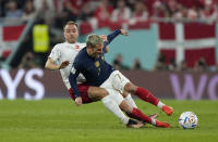 Denmark's Christian Eriksen, left, and France's Antoine Griezmann challenge during the World Cup group D soccer match between France and Denmark, at the Stadium 974 in Doha, Qatar, Saturday, Nov. 26, 2022. (AP Photo/Martin Meisner)