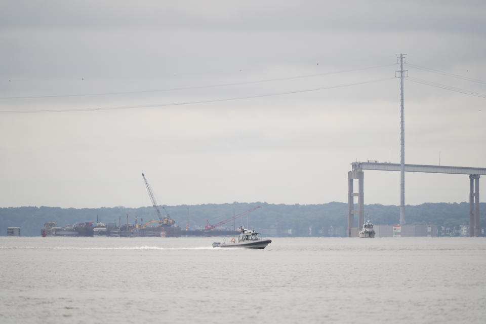 A boat passes near the collapsed Francis Scott Key Bridge, in Baltimore, Monday, May 20, 2024. (AP Photo/Matt Rourke)