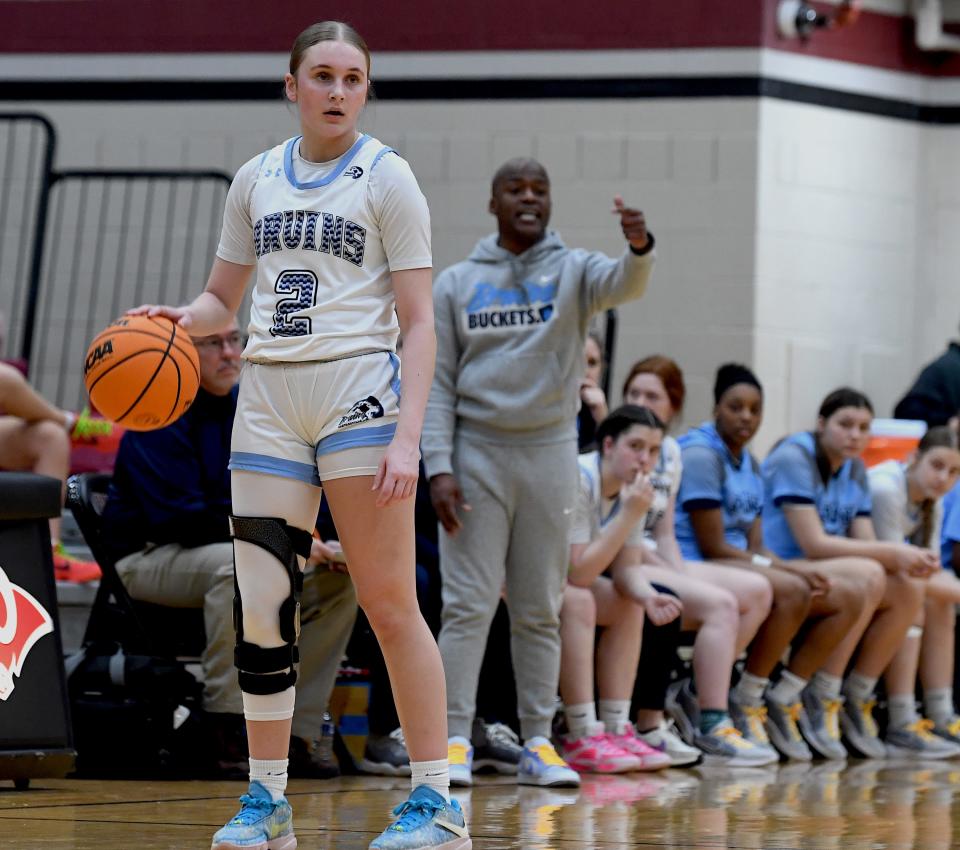 Bartlesville High School's senior Grace McPhail (2) checks the offense while Lady Bruins Head Coach Justyn Shaw directs traffic from the sideline in basketball action against Muskogee in playoff action in Owasso on Feb. 23, 2024. The Lady Bruins ended their season with a loss on Saturday.