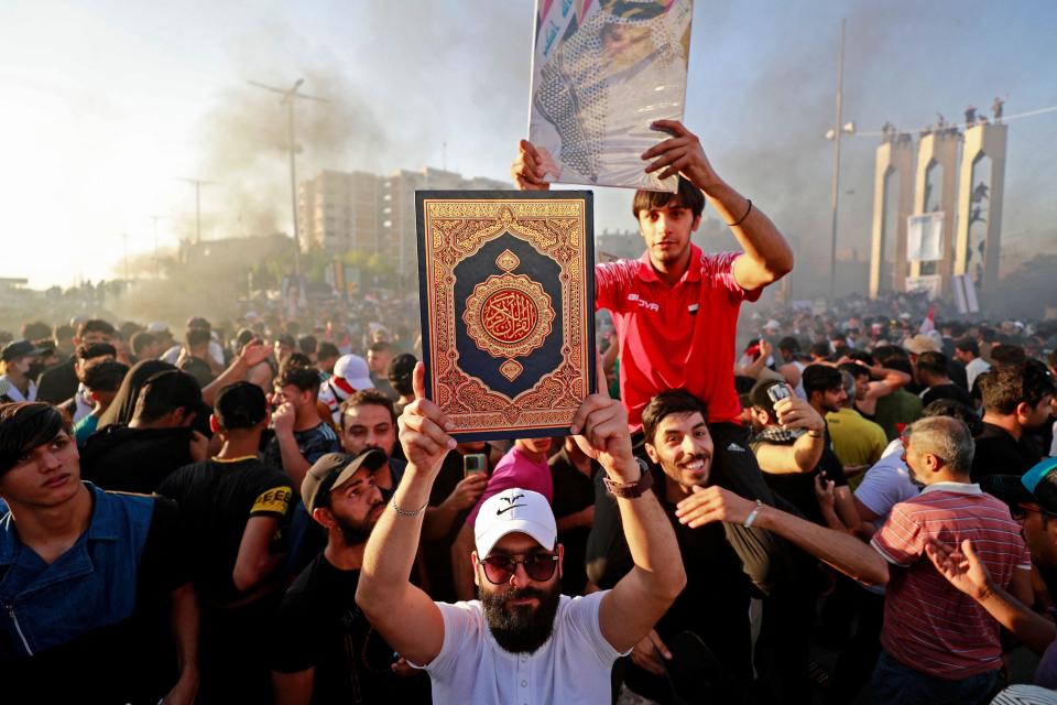 A supporter of Iraq's Sadrist movement holds up a copy of the Quran outside the Swedish Embassy in Baghdad, Iraq, June 30, 2023, during a second day of protests against the burning of a Quran outside a Stockholm mosque that outraged Muslims  around the world. / Credit: AHMAD AL-RUBAYE/AFP/Getty