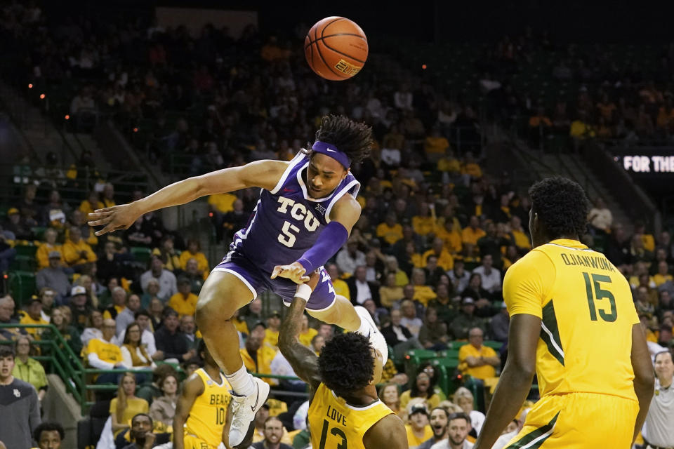 TCU forward Chuck O'Bannon Jr. (5) collides with Baylor guard Langston Love (13), and is called for an offensive foul during the first half of an NCAA college basketball game in Waco, Texas, Wednesday, Jan. 4, 2023. (AP Photo/LM Otero)