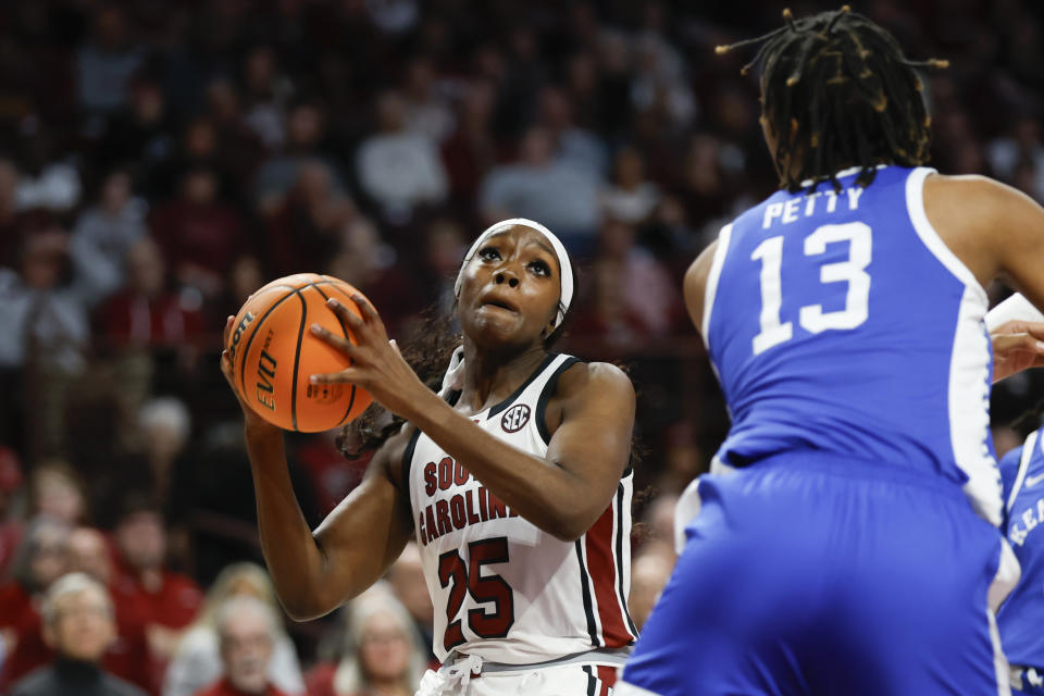 South Carolina guard Raven Johnson (25) drives to the basket against Kentucky forward Ajae Petty (13) during the first half of an NCAA college basketball game in Columbia, S.C., Monday, Jan. 15, 2024. (AP Photo/Nell Redmond)