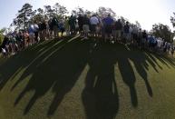 Patrons gather around the first green during the second round of the Masters golf tournament at the Augusta National Golf Club in Augusta, Georgia April 11, 2014. REUTERS/Mike Segar (UNITED STATES - Tags: SPORT GOLF)