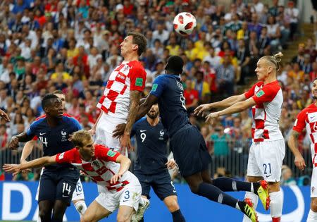 Croatia's Mario Mandzukic scores an own goal and the first goal for France. REUTERS/Kai Pfaffenbach