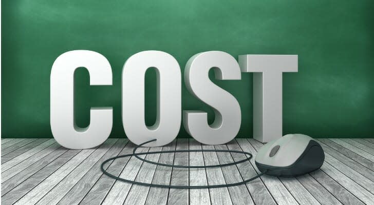 Computer mouse in front of block letters spelling the word "COST"