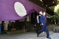 Former Japanese Prime Minister Shinzo Abe, right, leaves after praying at Yasukuni Shrine in Tokyo Wednesday, April 21, 2021, the first day of the annual Spring Rites, the shrine’s biannual festival honoring the war dead, including Japanese war criminals. (Tsuyoshi Ueda/Kyodo News via AP)