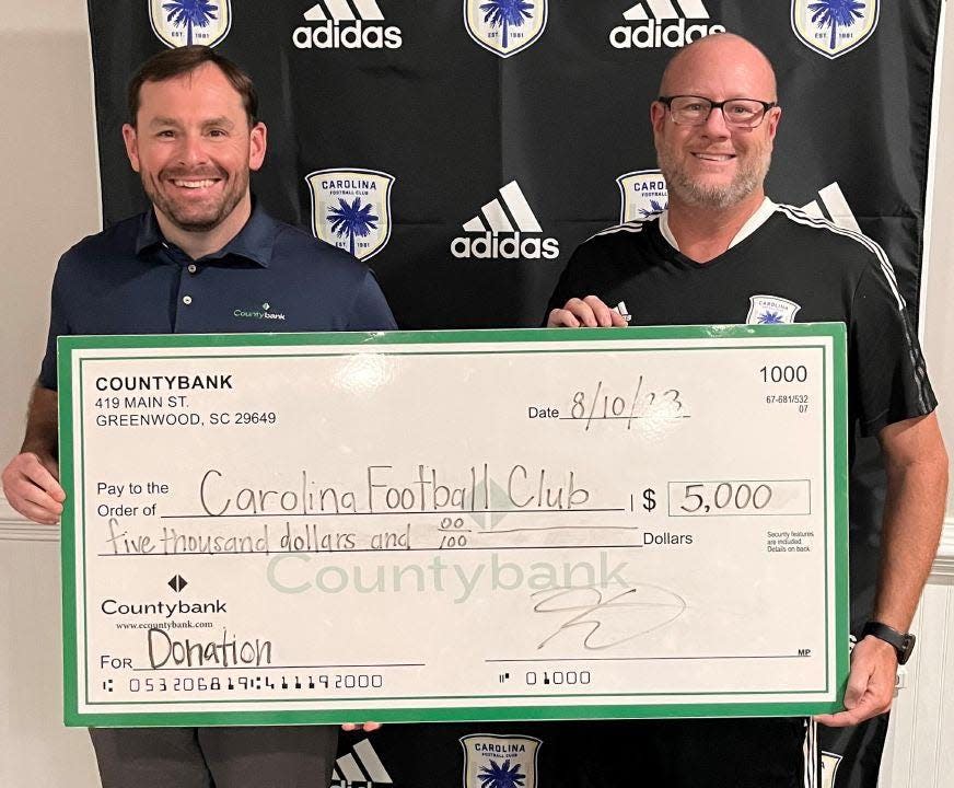 Kevin Duncan, left, Greer Market Executive for Countybank, and Rick Parlow, Executive Director, Carolina Football Club