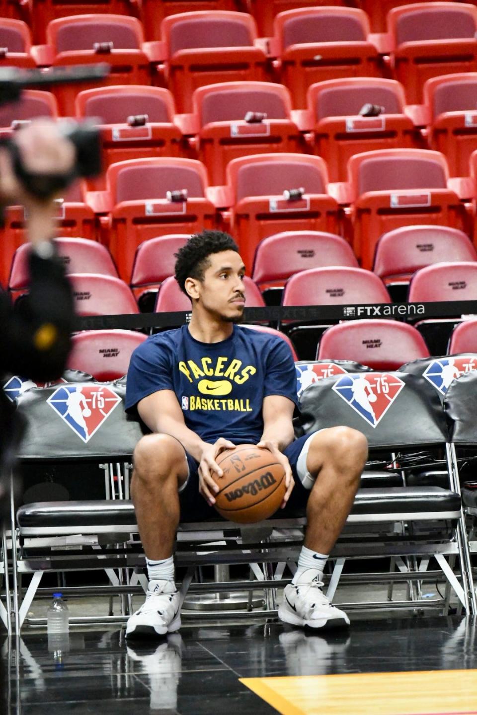 Malcolm Brogdon watches as the Pacers warm up against the Heat at FTX Arena in Miami on Dec. 21, 2021.