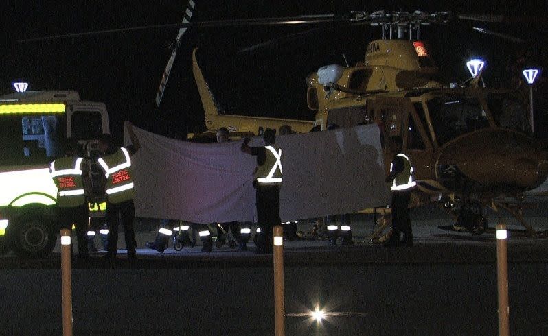 Paramedics transport two injured children from the RAC Rescue chopper to an ambulance to be taken to PMH. Picture: Seven News.