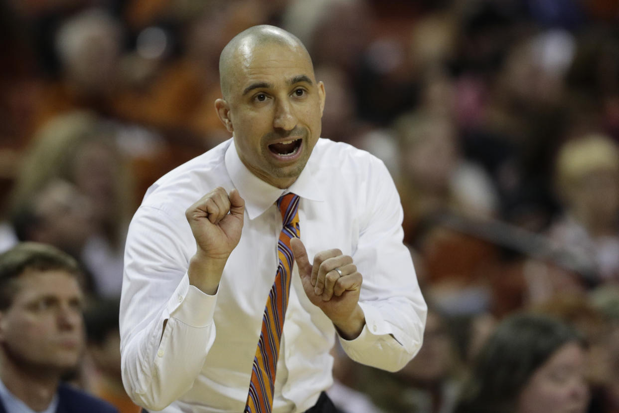 A bald Shaka Smart coaches during a game.