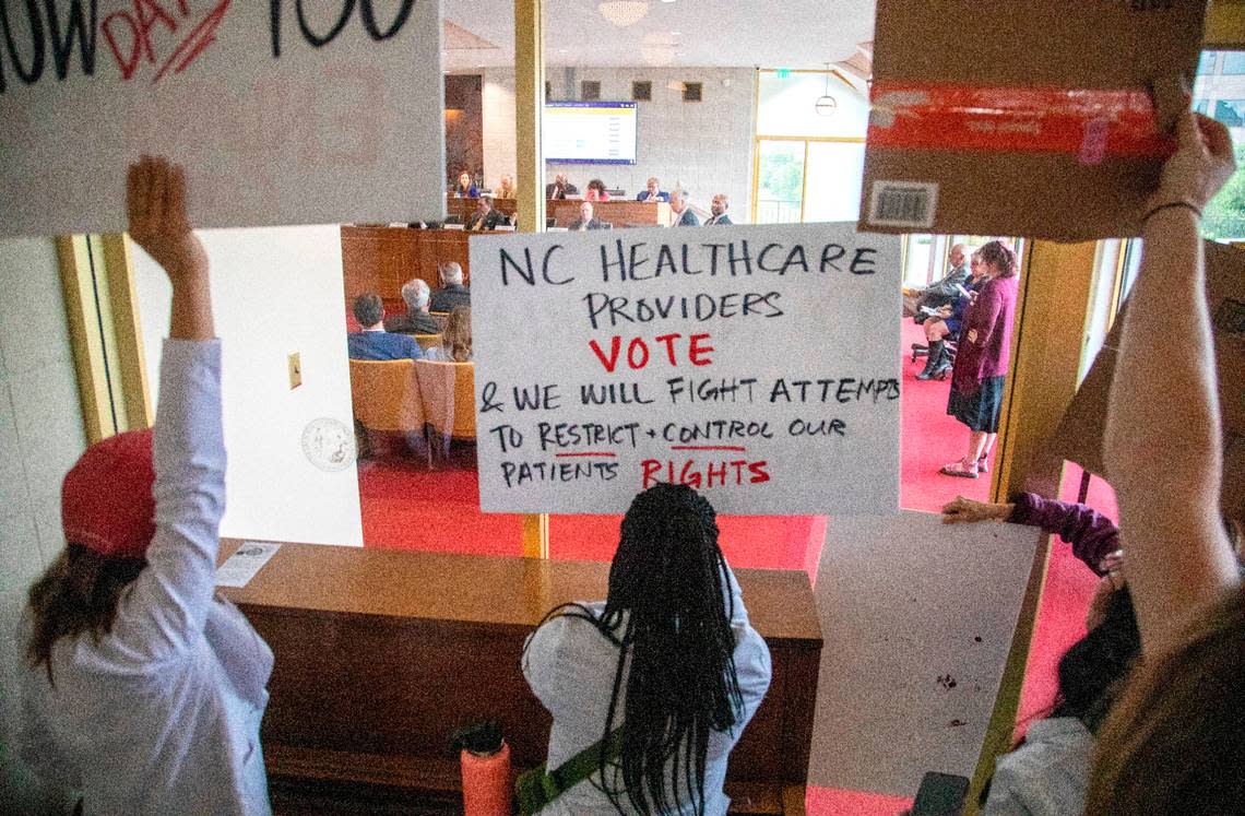 Demonstrators hold signs outside the legislature auditorium where a House Rules meeting was underway, May 3, 2023 at the Legislative Building. Republican state lawmakers announced their plan to limit abortion rights across the state. Travis Long/tlong@newsobserver.com