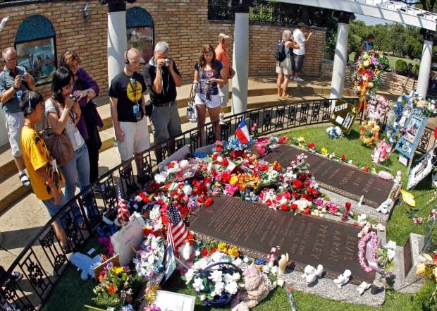 Elvis Presley fans view his grave at Graceland in 2010.  