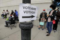 FILE - In this Saturday, Oct. 24, 2020, file photo, Westchester County residents stand in line to vote on the first day of early voting, in Yonkers, N.Y. Tens of millions of Americans already cast ballots in the 2020 election amid record-breaking early voting during the coronavirus pandemic. But for some voters in a handful of states, casting an early ballot in-person isn't even an option. (AP Photo/Julie Jacobson, File)