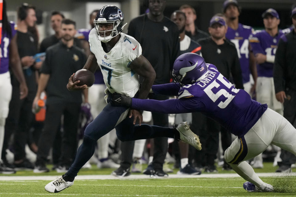 Tennessee Titans quarterback Malik Willis (7) runs the ball as Minnesota Vikings linebacker Andre Carter II (55) makes the stop in the second half of a preseason NFL football game, Saturday, Aug. 19, 2023, in Minneapolis. (AP Photo/Charlie Neibergall)