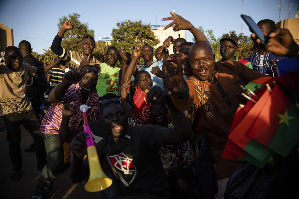 A crowd gathered Place de la Nation celebrate at the announcement that Lt. Col. Paul Henri Sandaogo Damiba has taken the reins of the country in Ouagadougou Monday Jan. 24, 2022. More than a dozen mutinous soldiers declared Monday on state television that a military junta now controls Burkina Faso after they detained the democratically elected president following a day of gun battles in the capital. (AP Photo/Sophie Garcia)