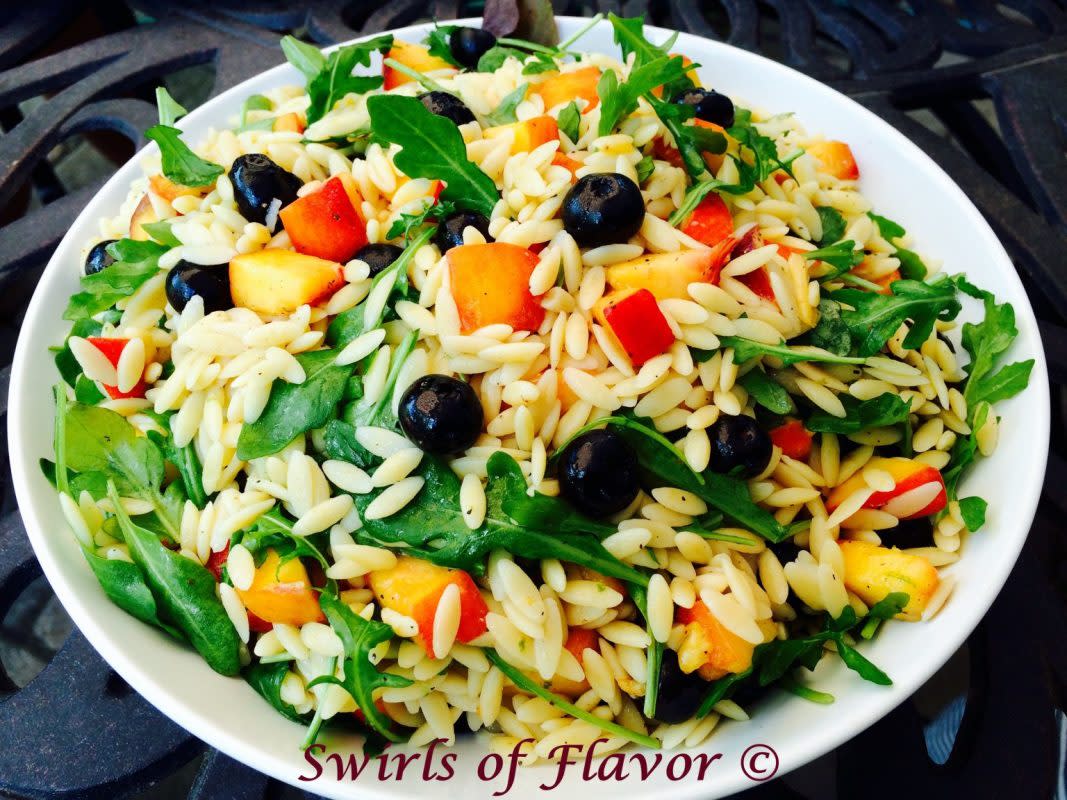 <p>This lime-kissed orzo pasta is studded with fresh juicy peaches and succulent blueberries and tender peppery arugula leaves offset the fruity sweetness creating a perfect balance of flavors. </p><p><strong>Get the recipe:</strong><a href="https://swirlsofflavor.com/blueberry-peach-orzo/?fbclid=IwAR25sSVJGwBJqcjSCLl_Idx7Edwwmwryh-hrDsptNcnt4ky3IOiNmksPRkQ" rel="nofollow noopener" target="_blank" data-ylk="slk:Blueberry Peach Orzo;elm:context_link;itc:0;sec:content-canvas" class="link rapid-noclick-resp"> <strong>Blueberry Peach Orzo</strong></a></p>