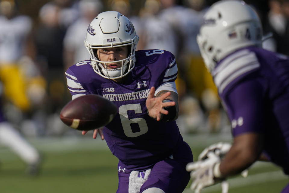 Northwestern quarterback Brendan Sullivan (6) tosses the ball during the first half of an NCAA college football game against Iowa, Saturday, Nov. 4, 2023, at Wrigley Field in Chicago. (AP Photo/Erin Hooley)