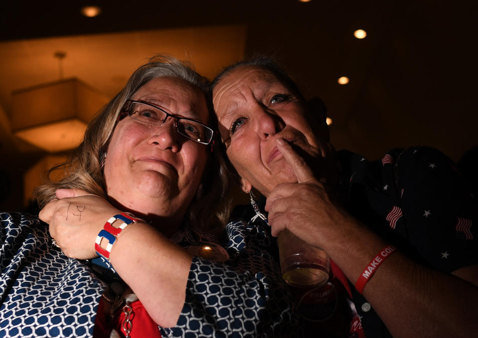 Laurel Imer, Jefferson County Chair for the Trump Campaign, left, and Robyn McMillen, Trump supporter, embrace each other as the watch returns come in during the Colorado Republican Election Night party at the DoubleTree Hilton in the Denver Tech Center, on Nov. 8.&nbsp;