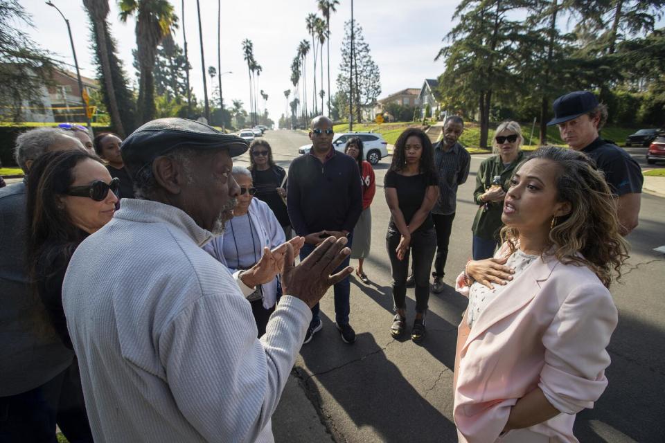 Resident Douglas Alston, left, voices his concerns to Aura Vasquez, a candidate for Los Angeles City Council District 10.