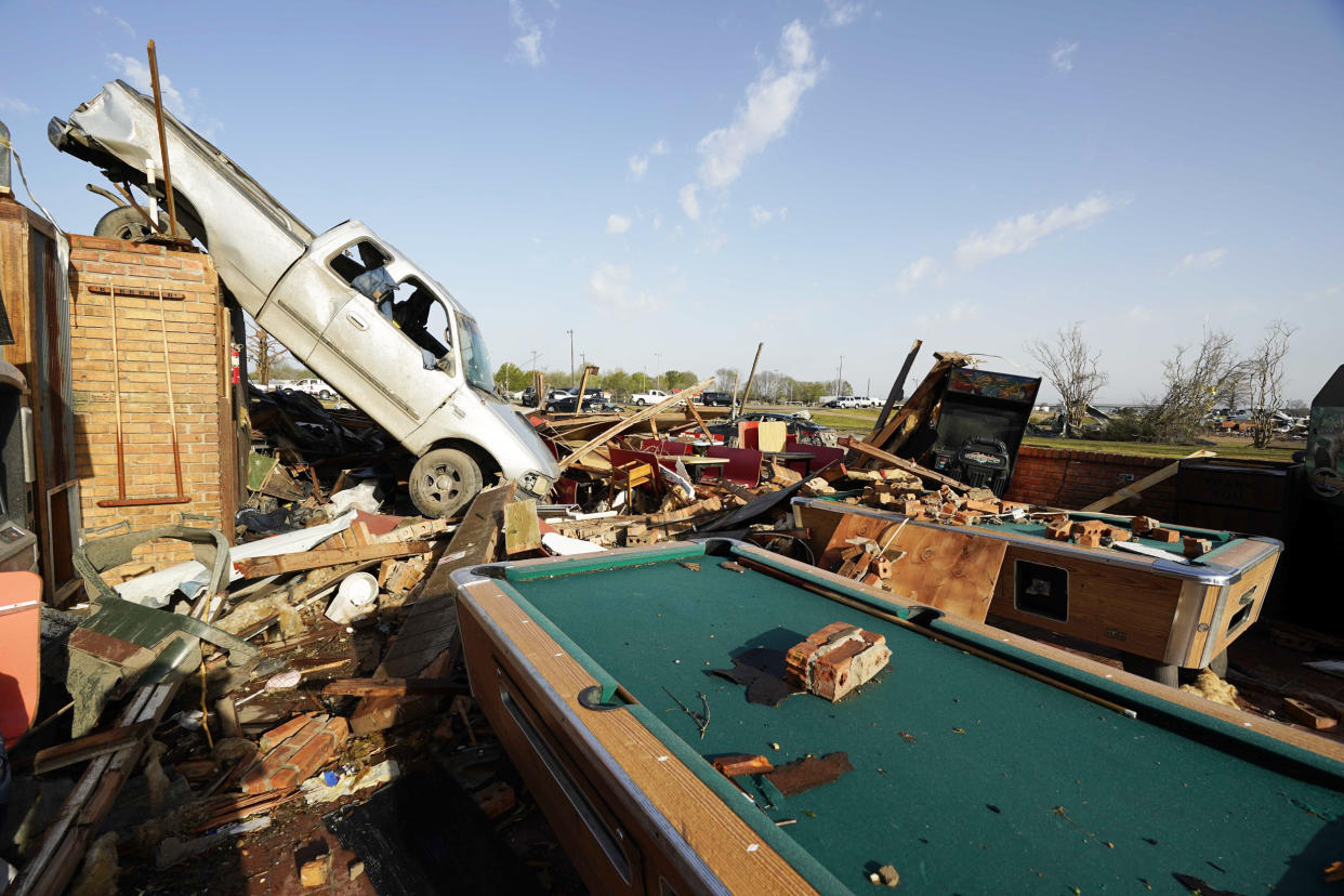A pickup truck rests on top of a restaurant cooler at Chuck's Dairy Cafe in Rolling Fork, Miss. (Rogelio V. Solis / AP)