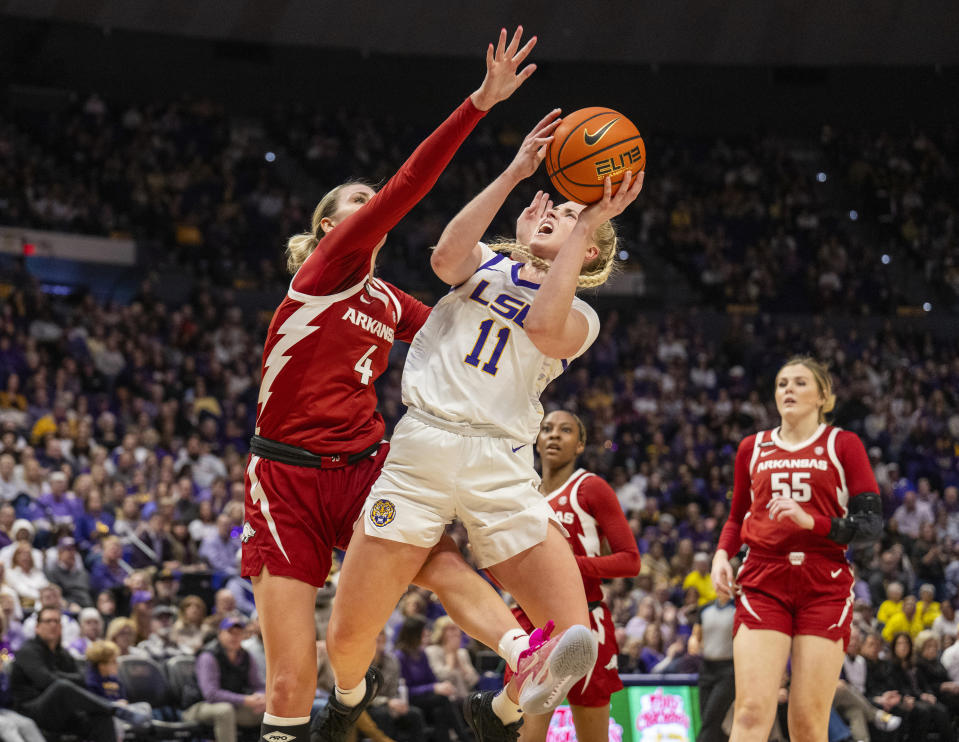 LSU guard Hailey Van Lith (11) is fouled by Arkansas guard Saylor Poffenbarger (4) in the second period of an NCAA college basketball game Sunday, Jan. 21, 2024, in Baton Rouge, La. (Michael Johnson/The Advocate via AP)