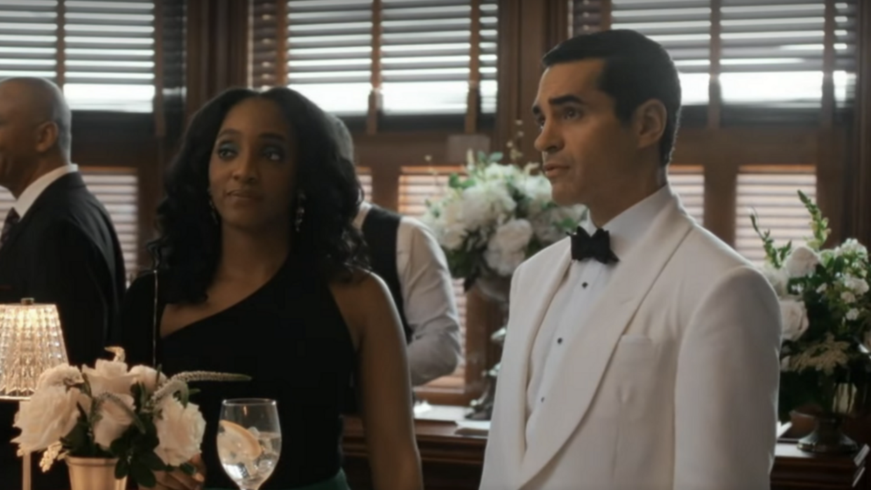  Iantha Richardson as Faith and Ramon Rodriguez as Will Trent at a wedding in Will Trent Season 2x07. 