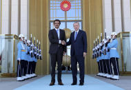 Turkey's President Recep Tayyip Erdogan, right, and Qatar's Emir Sheikh Tamim bin Hamad Al Thani shake hands before their talks in Ankara, Turkey, Wednesday, Aug. 15, 2018. Sheikh Al Thani is in Turkey for a one-day working visit.(Presidential Press Service via AP, Pool)