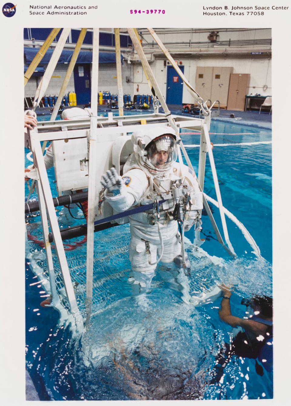 Astronaut Carl J Meade, STS-64 mission specialist, is being submerged prior to an underwater simulation of a space walk scheduled for his September mission, 10th August 1994.