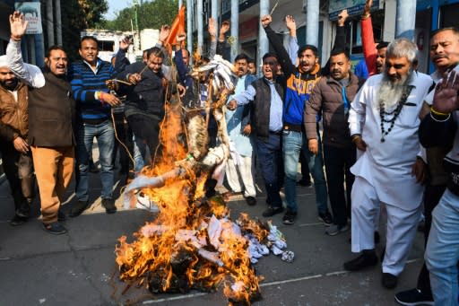 Activists protest against the rape and murder of a 27-year-old woman in India; police later shot dead the four detained suspects at the scene of the alleged crime