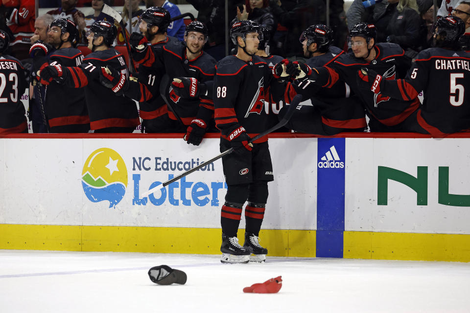 Carolina Hurricanes' Martin Necas (88) is congratulated along the bench following his hat trick goal during the first period of an NHL hockey game against the Colorado Avalanche in Raleigh, N.C., Thursday, Feb. 8, 2024. (AP Photo/Karl B DeBlaker)