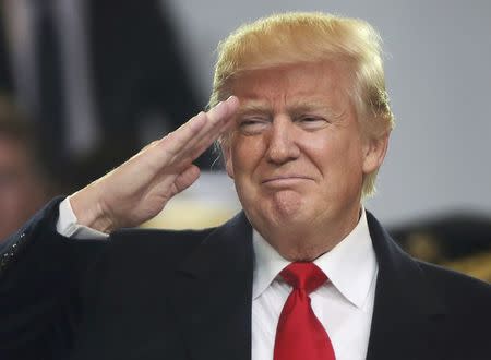 U.S. President Donald Trump salutes participants during the inaugural parade in Washington, January 20, 2017. REUTERS/Carlos Barria