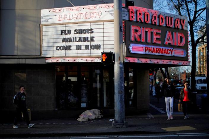 FILE PHOTO: The sign over a drug store advertises flu shots amid the coronavirus outbreak in Seattle