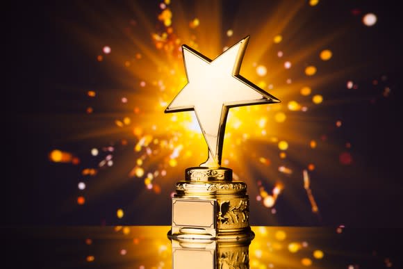 Closeup of a sparkling gold trophy with a star design.