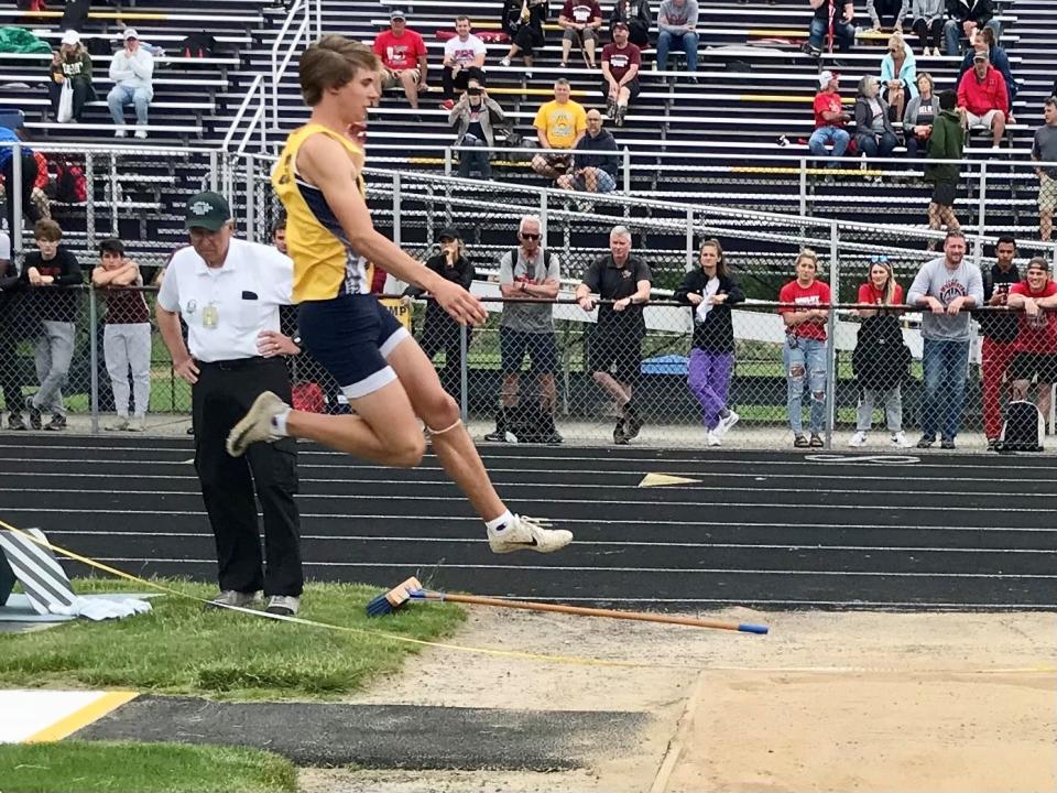 River Valley junior Grant Butler competes in the Division II regional boys long jump at Lexington High School this season. Butler was competing in varsity track for the first time this year.