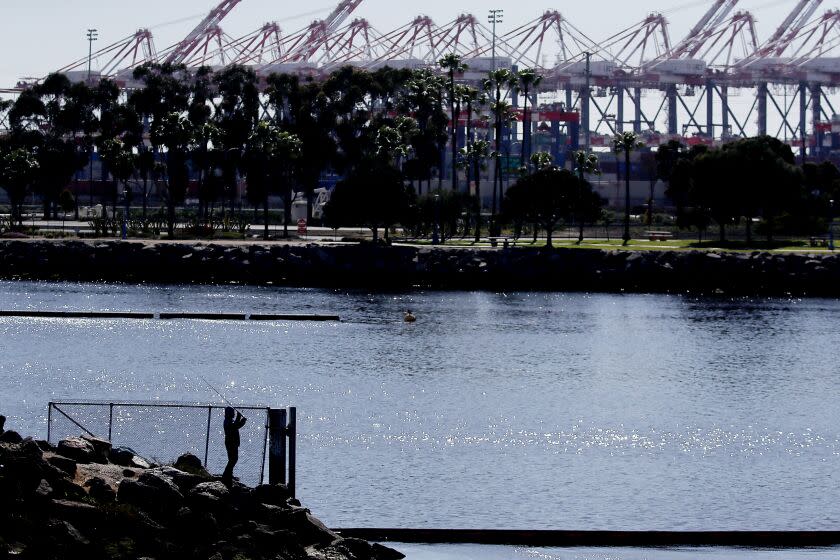 LONG BEACH, CALIF. - MAR. 6, 20222. A fisherman casts a line into the mouth of the Los Angeles River where it empties into the Port of Long Beach. (Luis Sinco/ Los Angeles Times)