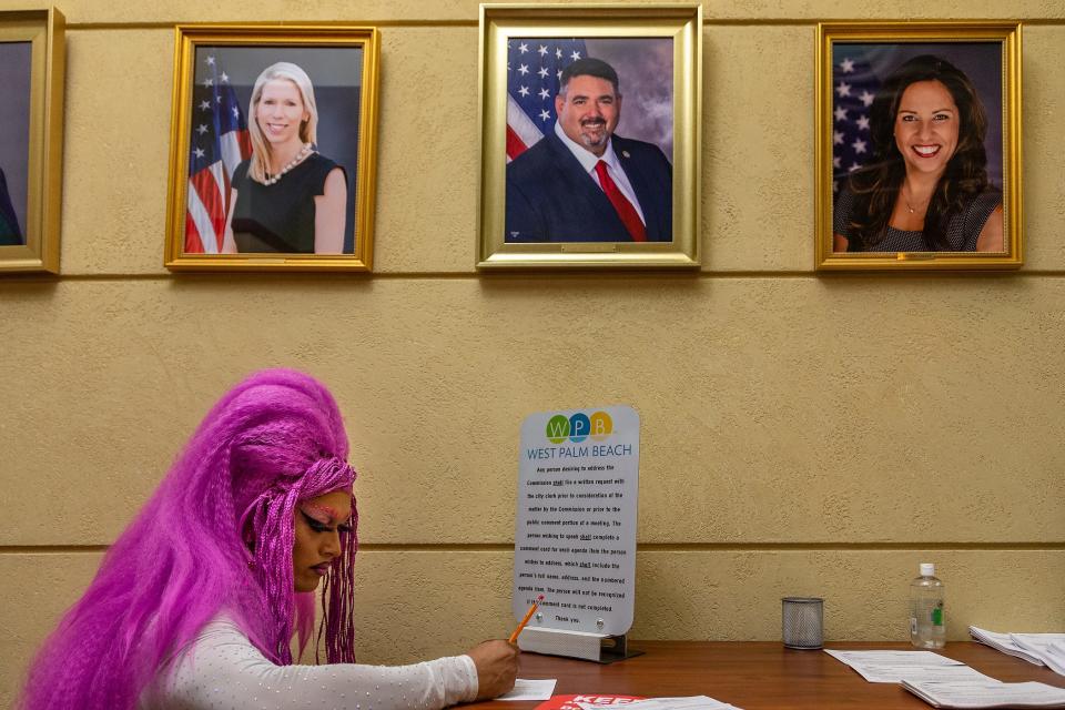 Edgar Rivas, Stuart, fills out a public comment card before the city commission meeting at city hall in downtown West Palm Beach.