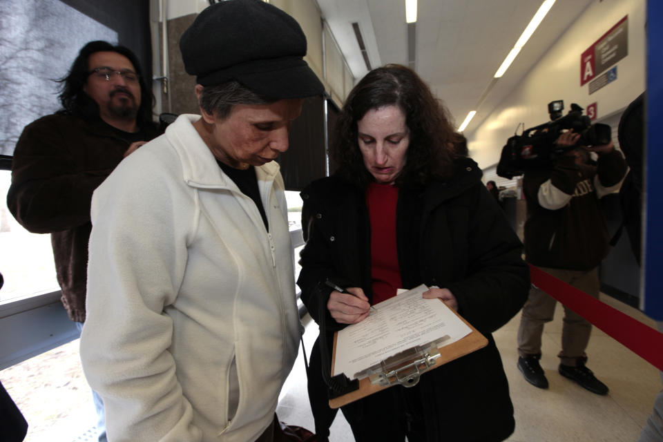 Theresa Guillen, left, and Lori Klein Shapiro, fill out information for a marriage license at the Oakland County Clerks office in Pontiac, Mich., Saturday, March 22, 2014. A federal judge has struck down Michigan's ban on gay marriage Friday the latest in a series of decisions overturning similar laws across the U.S. Some counties plan to issue marriage licenses to same-sex couples Saturday, less than 24 hours after a judge overturned Michigan's ban on gay marriage. (AP Photo/Paul Sancya)