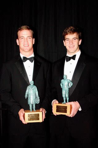 <p>Bill McCay/Getty</p> Peyton Manning and Eli Manning in 2004