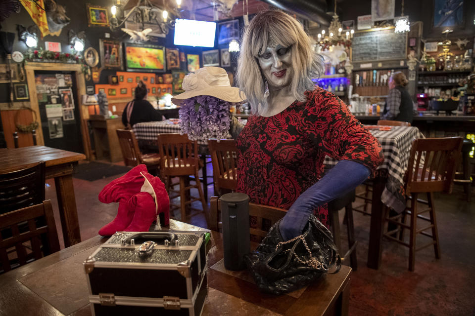 Emma Scott Lavin, who performs drag under the stage name We Are Belov3d, gathers her things at Old Nick's Pub Sunday, Oct. 30, 2022, in Eugene, Ore. Lavin confronted protesters at the venue where a Drag Queen Storytime was happening a week earlier. (AP Photo/Andy Nelson)