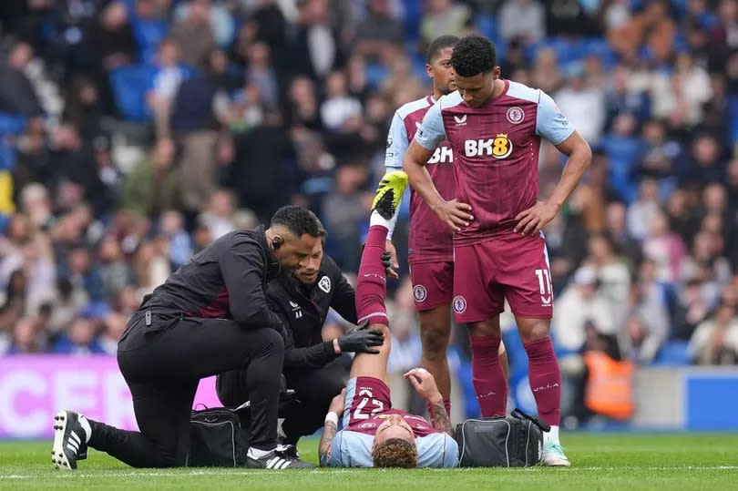 Aston Villa's Morgan Rogers receives treatment from medical staff during the Premier League match at the American Express Stadium, Brighton
