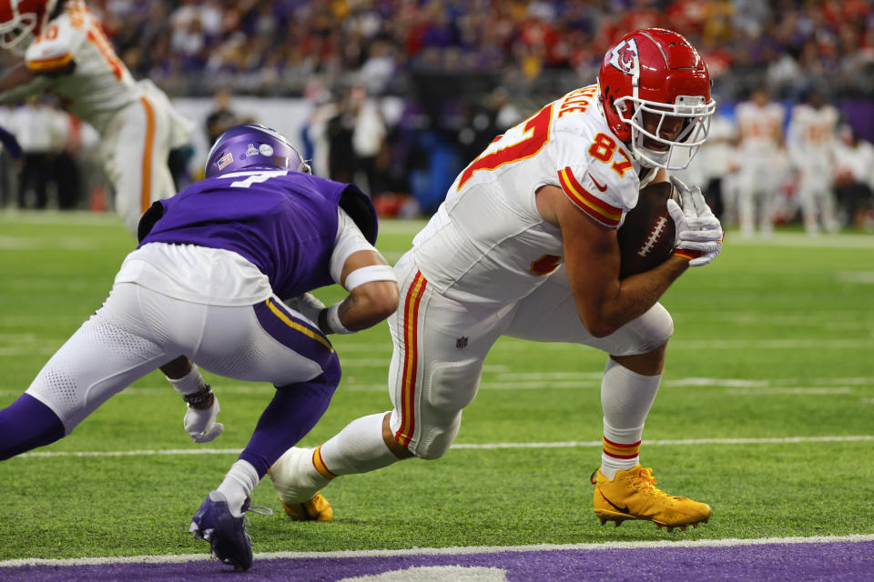 Kansas City Chiefs tight end Travis Kelce (87) catches a 4-yard touchdown pass in front of Minnesota Vikings cornerback Byron Murphy Jr., left, during the second half of an NFL football game, Sunday, Oct. 8, 2023, in Minneapolis. (AP Photo/Bruce Kluckhohn)