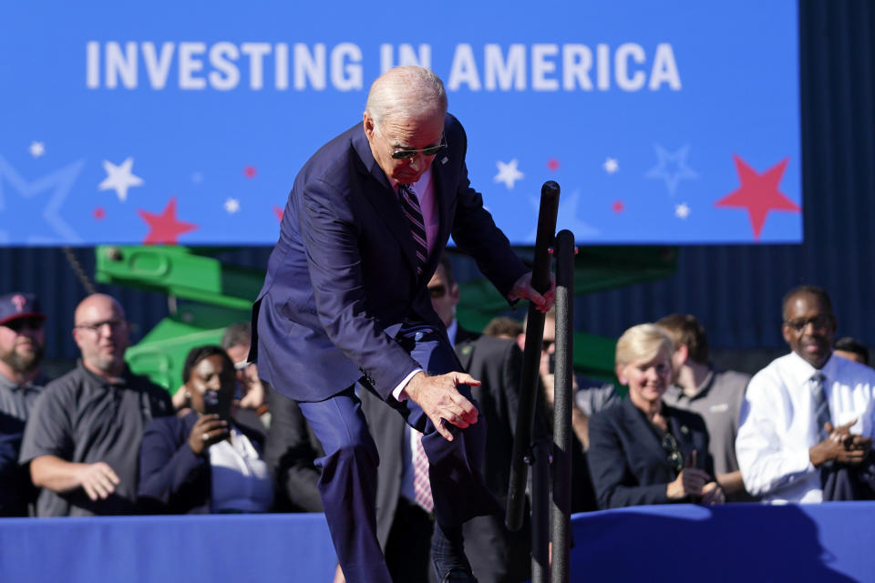 President Joe Biden stumbles as he walks on stage to speak at Tioga Marine Terminal, Friday, Oct. 13, 2023, in Philadelphia. (AP Photo/Evan Vucci)